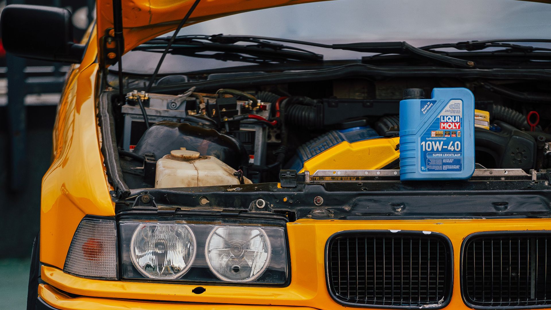Close-up of car engine and motor oil can at a garage in Sarajevo.