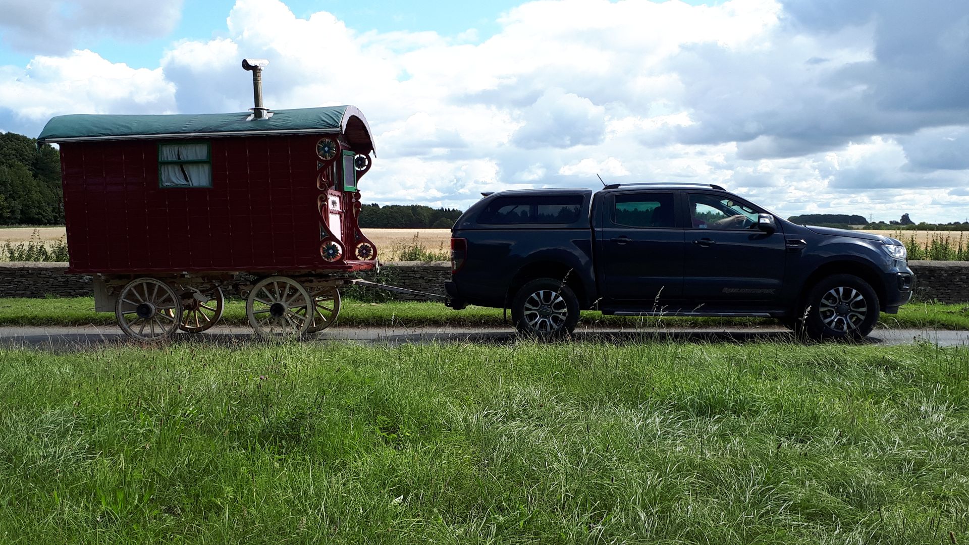 Car towing gypsy caravan on Salt Way