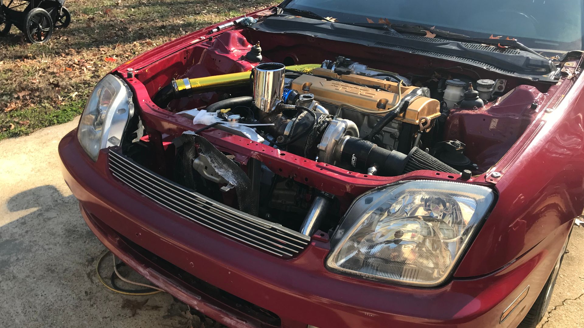 The engine bay of a modified turbo Honda prelude with an f20b