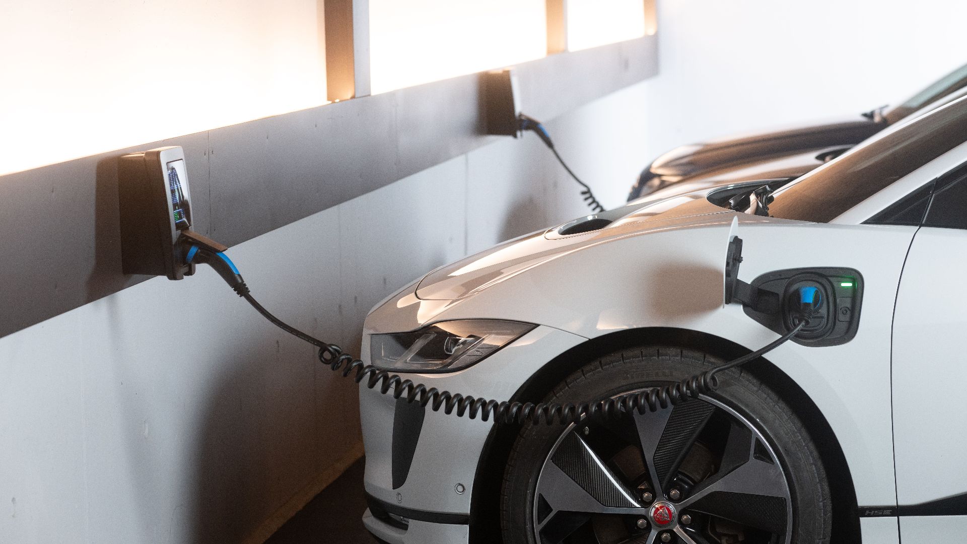 Electric car charging in a modern indoor station promoting sustainability and energy efficiency.