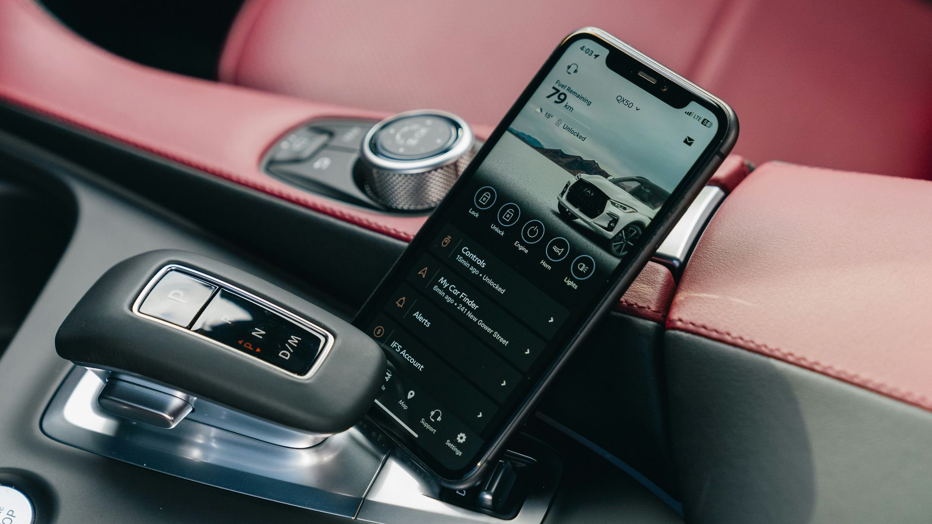Smartphone displaying car interface in car console