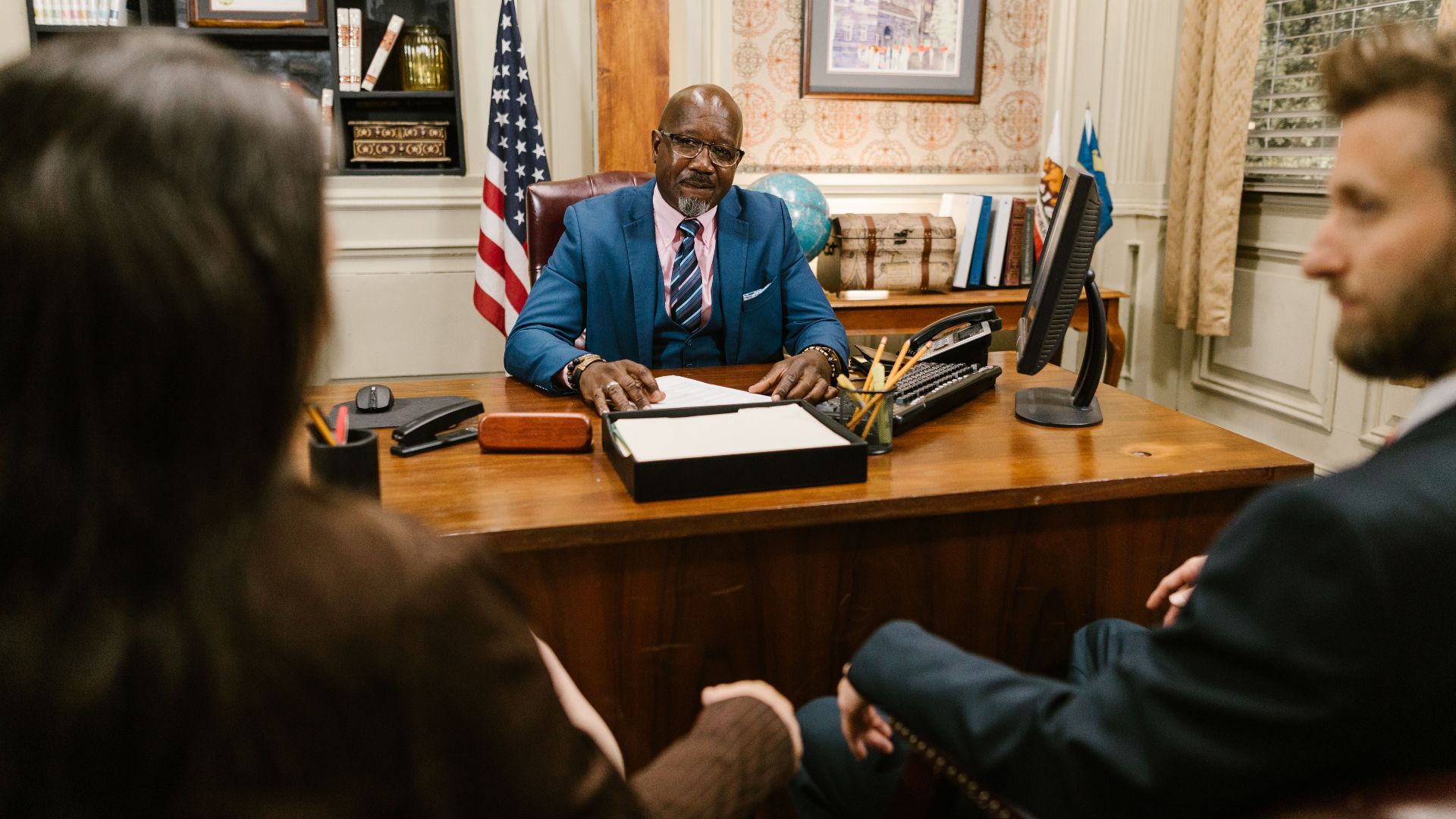A professional lawyer meeting with clients in his office at a legal consultation.