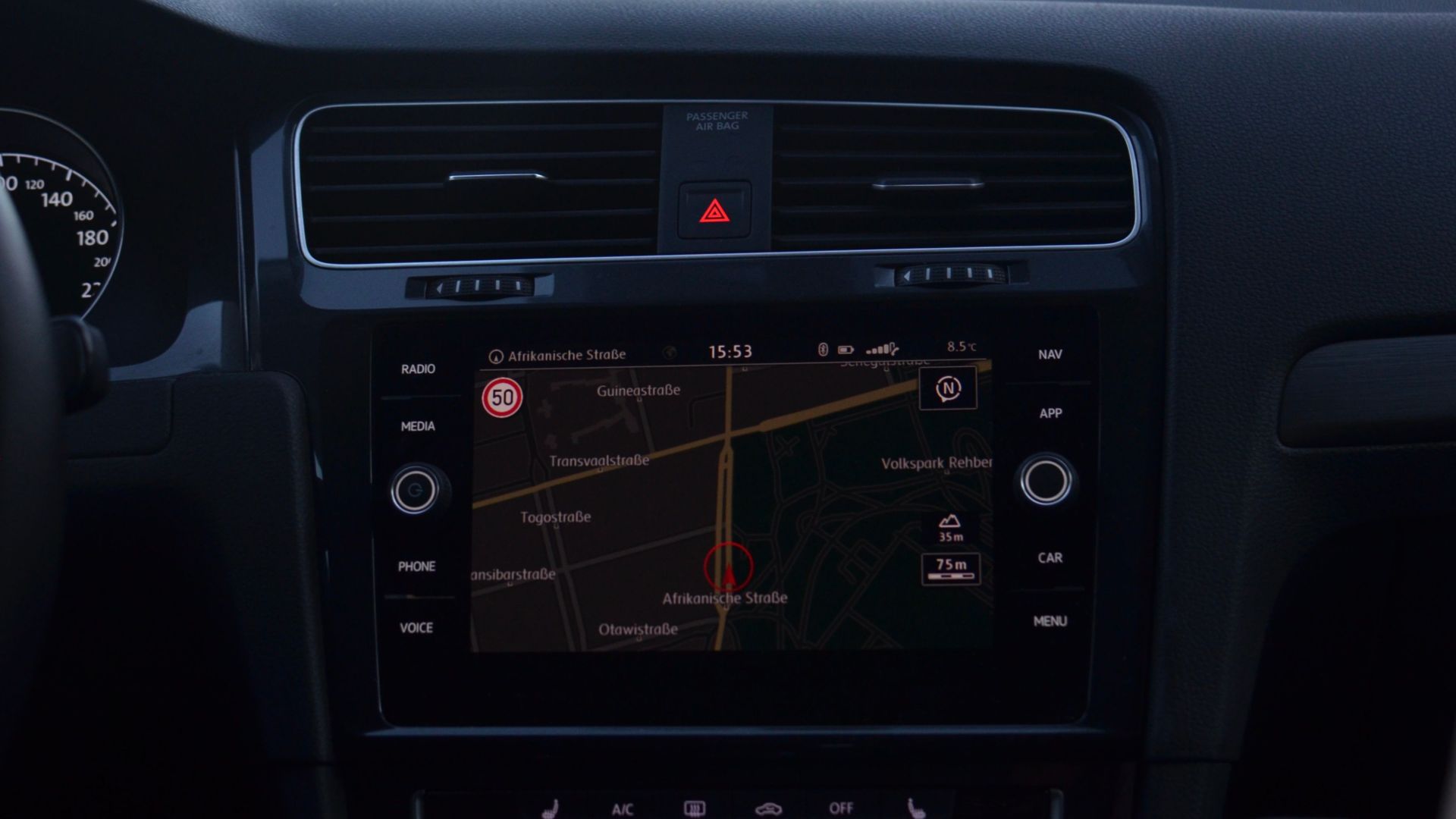 Interior of modern car with steering wheel and navigation system showing route through city streets