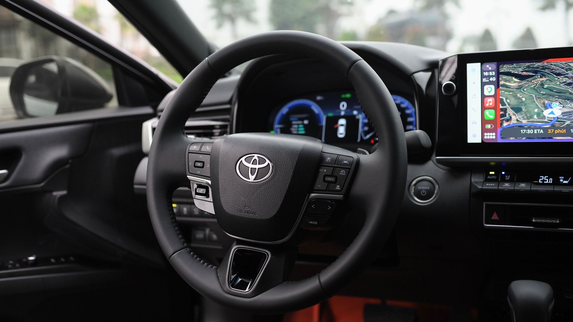 Interior view of a modern car showcasing the steering wheel, dashboard, and GPS display screen.