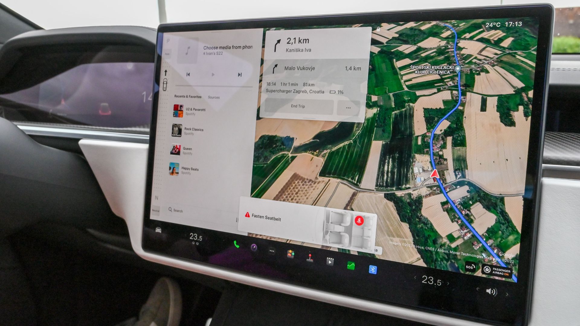 Inside view of a car with a large navigation screen and detailed digital map.