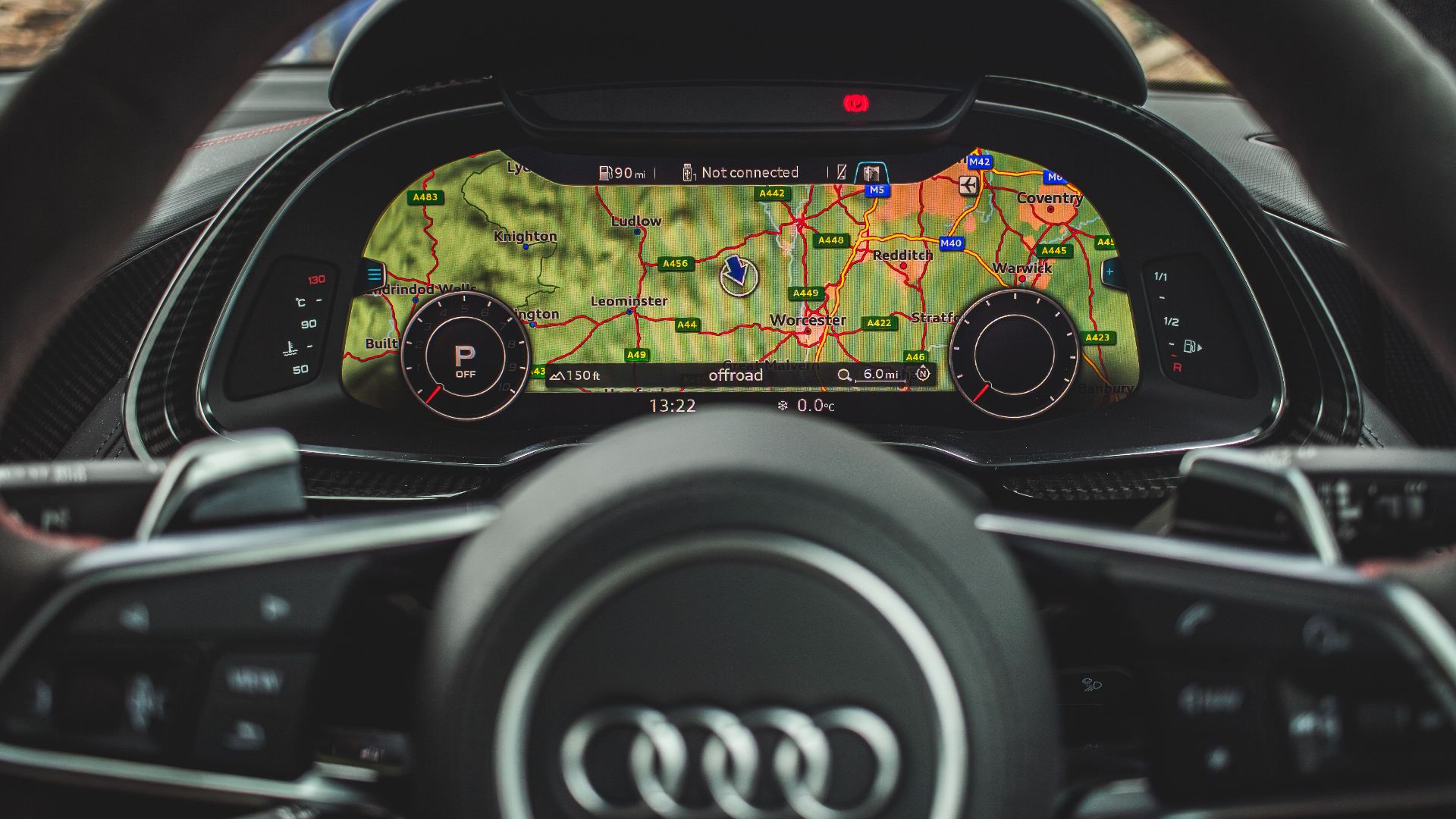 Car dashboard showing GPS navigation system with digital map in a luxury vehicle.