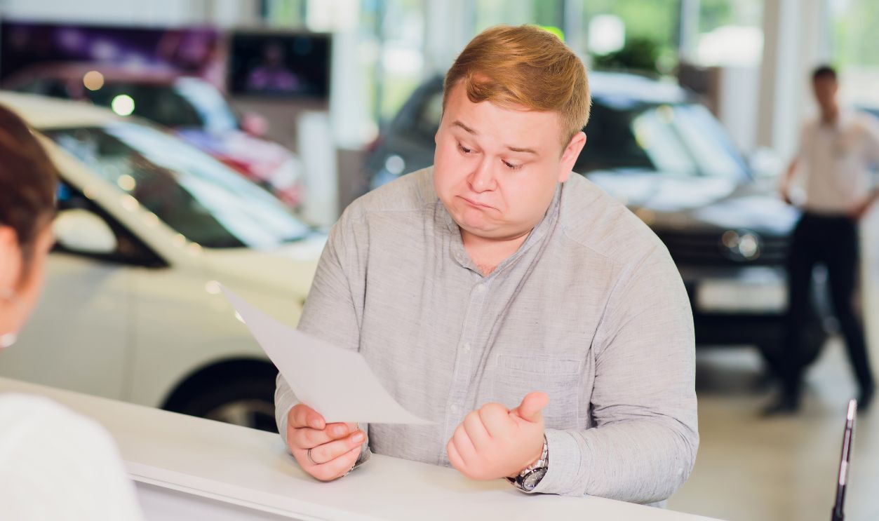 successful businessman in car dealership - sale of vehicles to customers