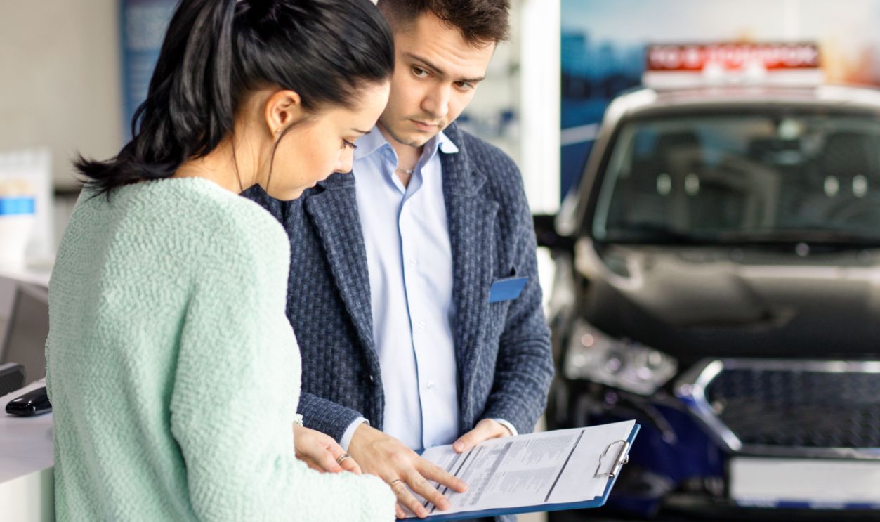 salesman presenting new car to clients