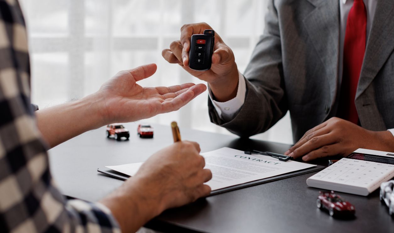 New car keys, Signing car insurance document or lease. Writing signature on contract or agreement. Buying or selling new or guarantee.