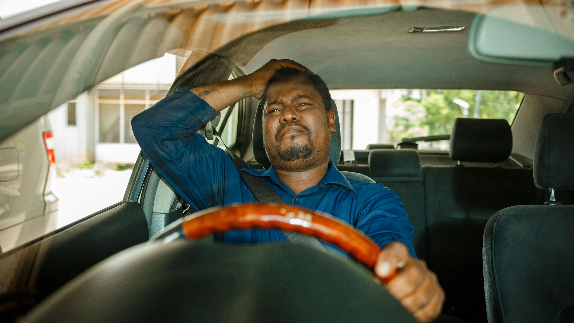 a man sitting in the driver's seat of a car