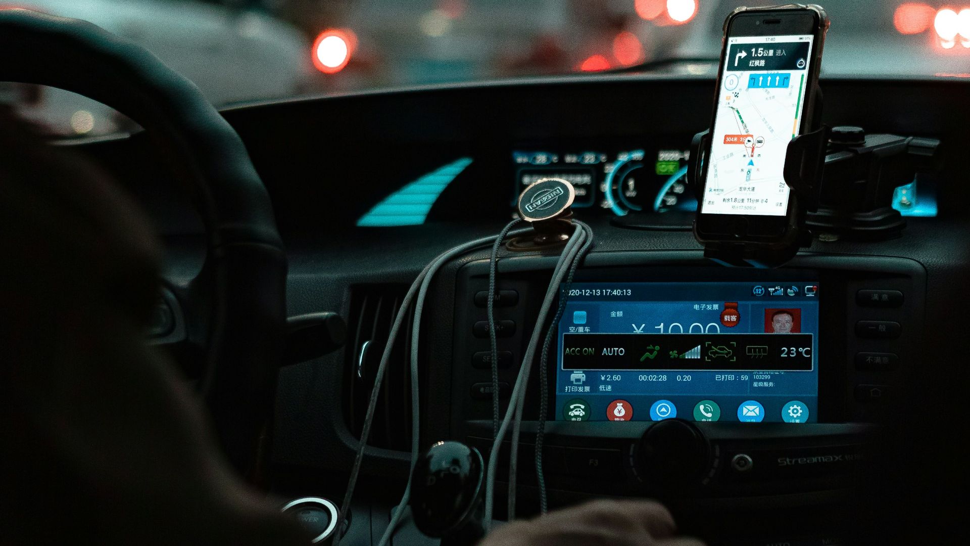 person holding iphone 6 taking photo of cars on road during night time