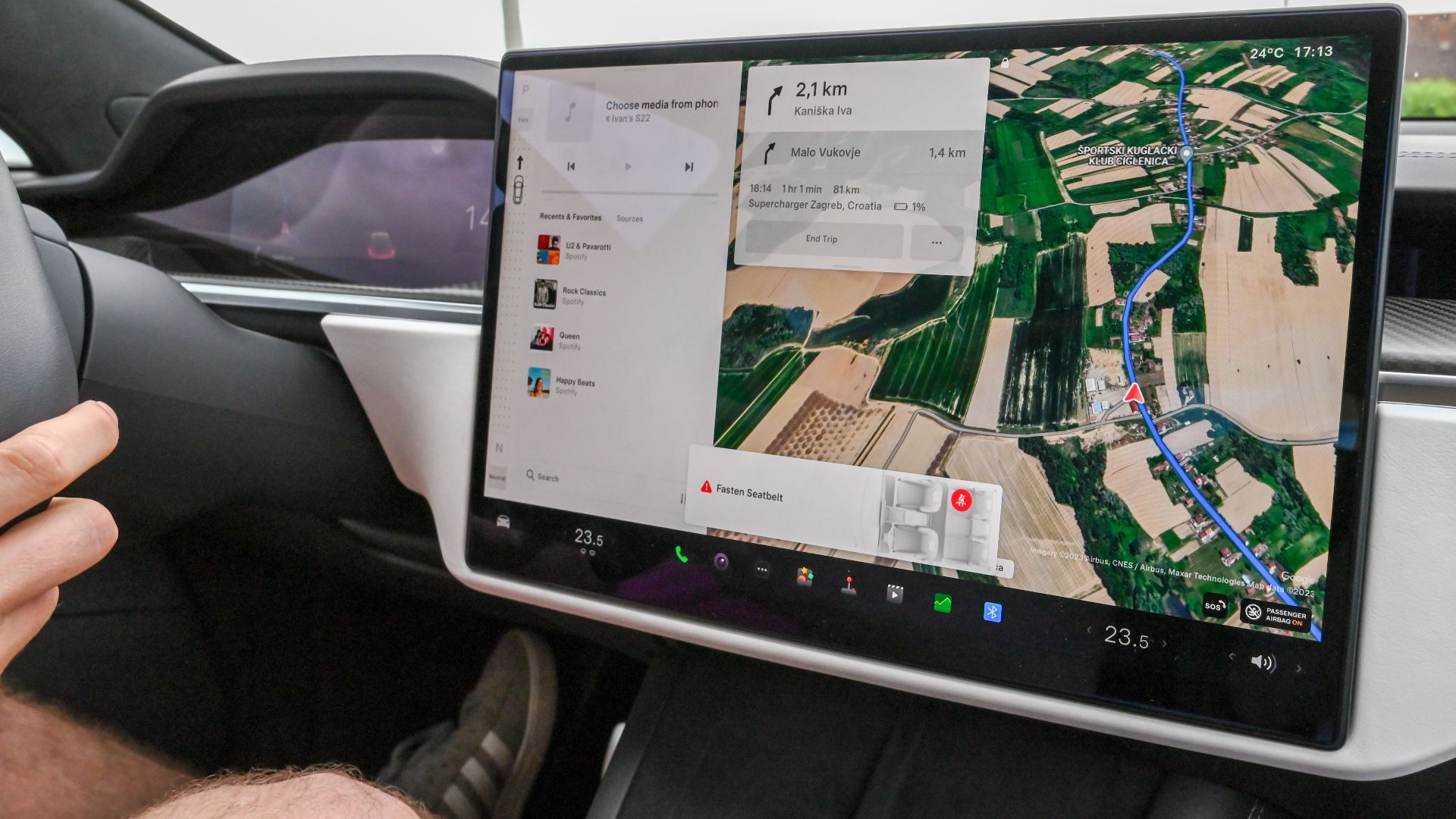 Inside view of a car with a large navigation screen and detailed digital map.