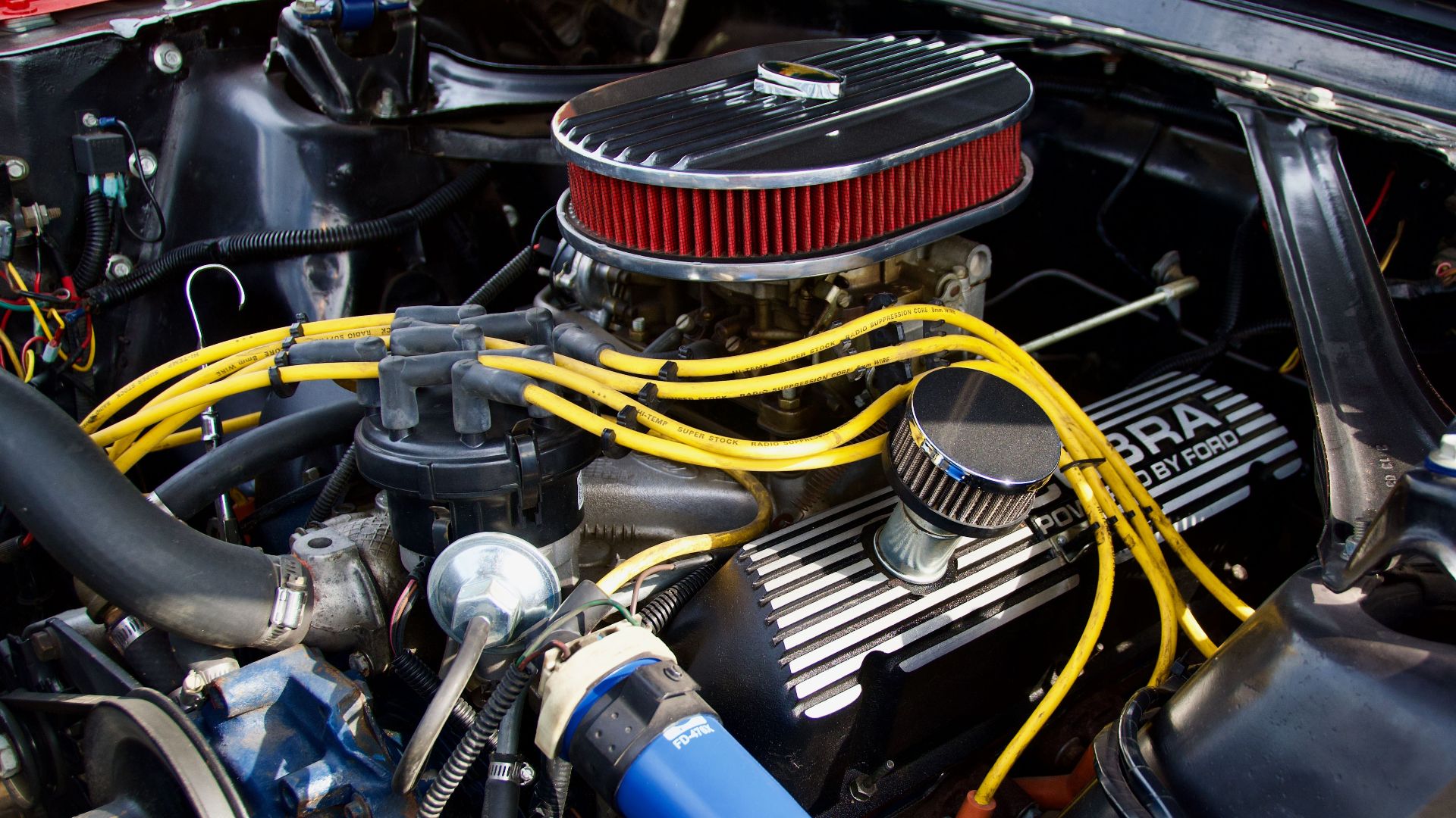 Detailed close-up of a Ford engine showcasing components and vibrant wiring.