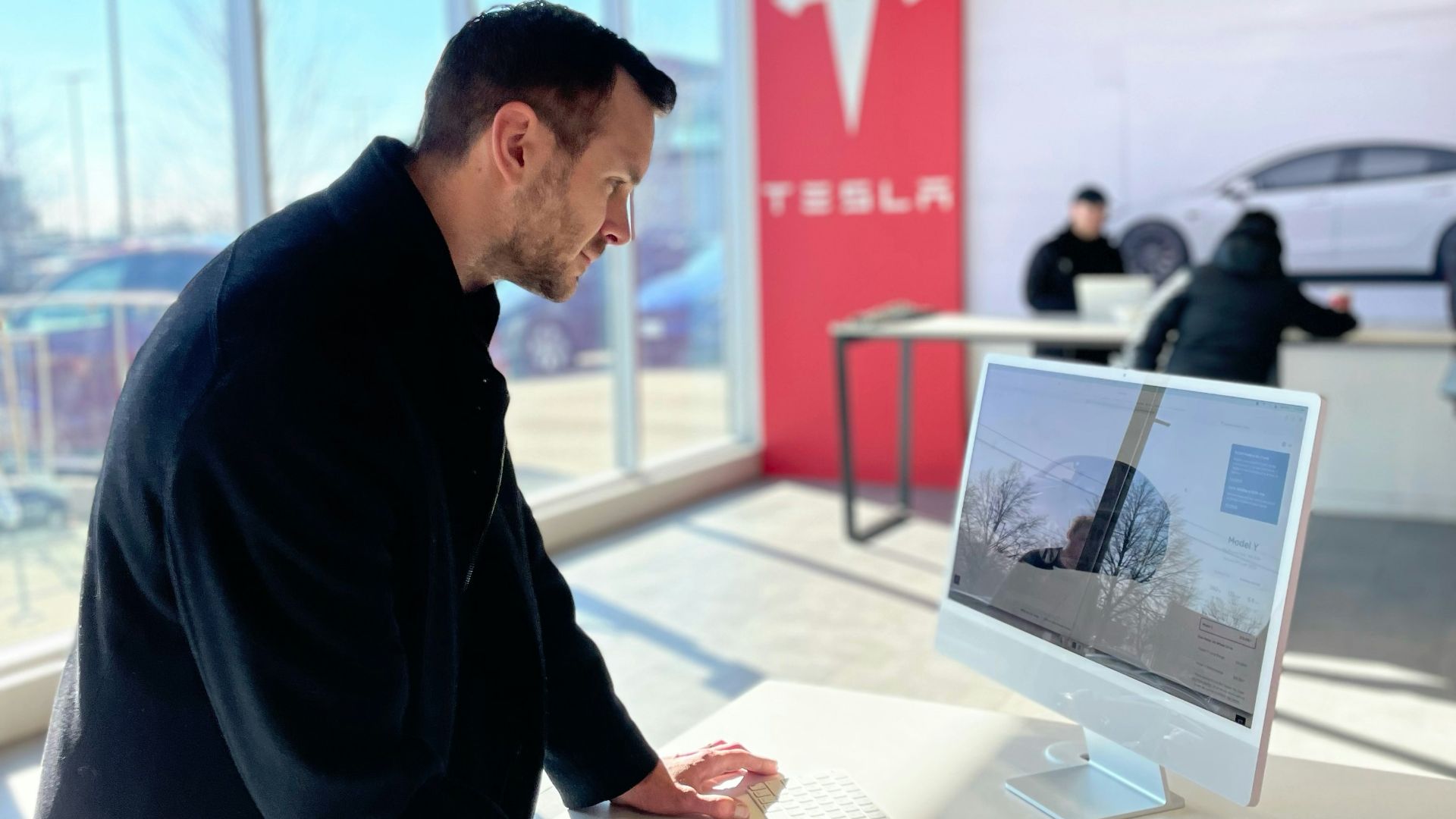 a man sitting at a desk in front of a computer