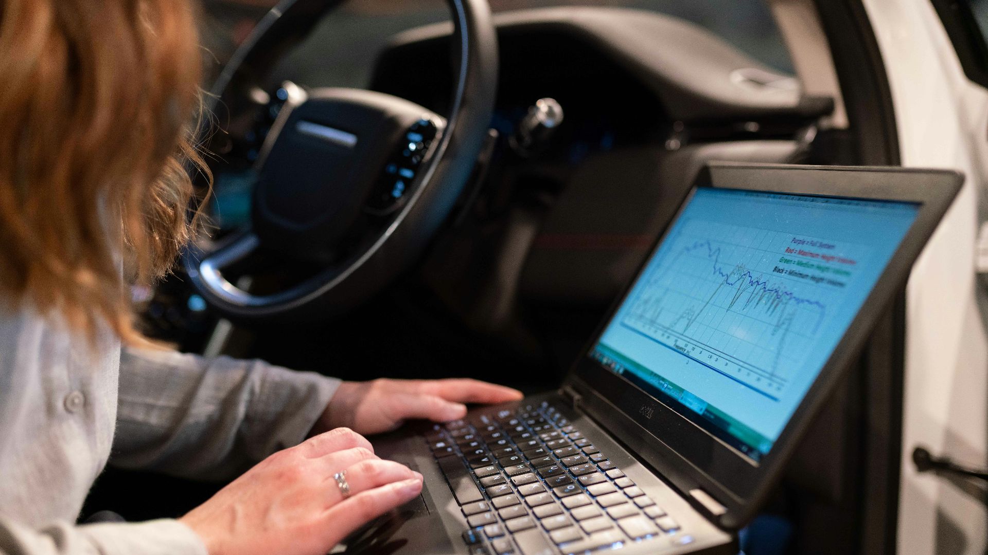 woman in gray long sleeve shirt using black laptop computer