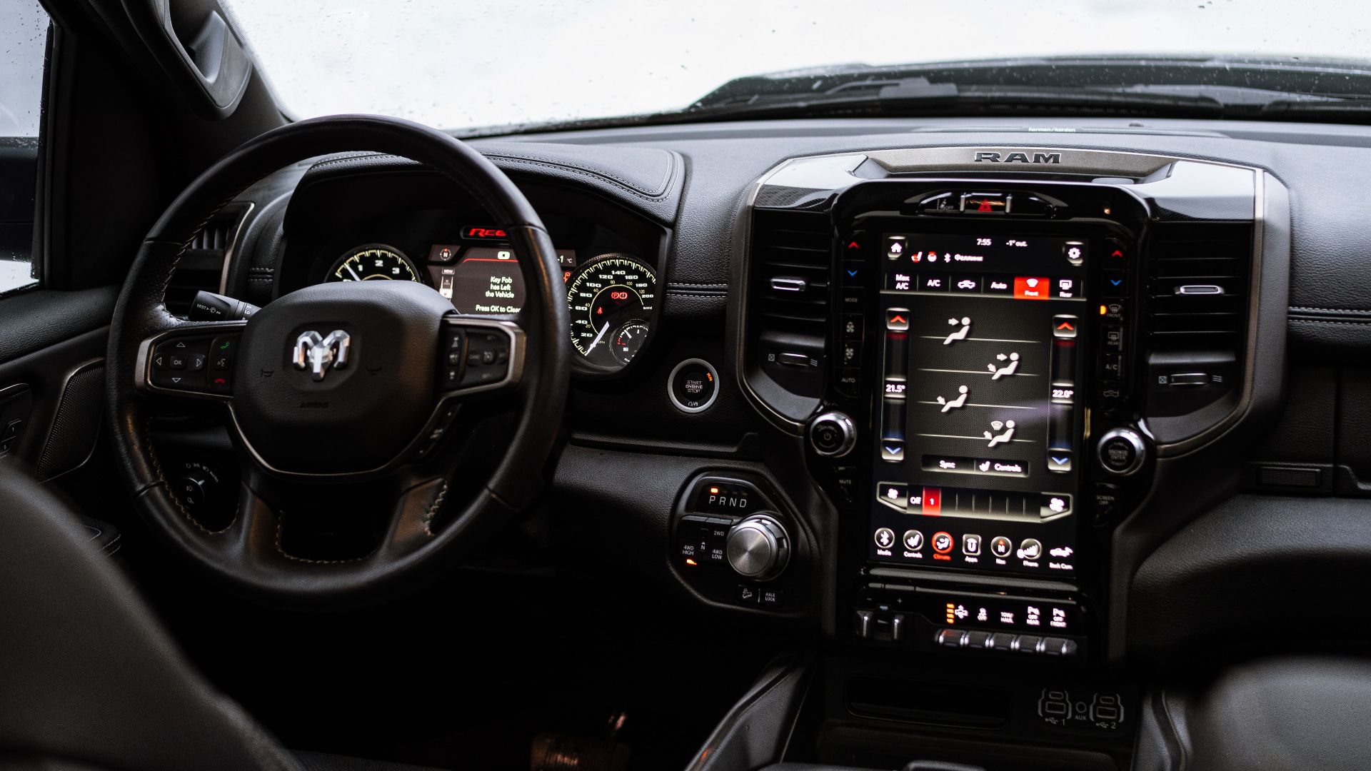 Close-up view of Dodge Ram 1500 Rebel truck dashboard and steering wheel in a modern interior.