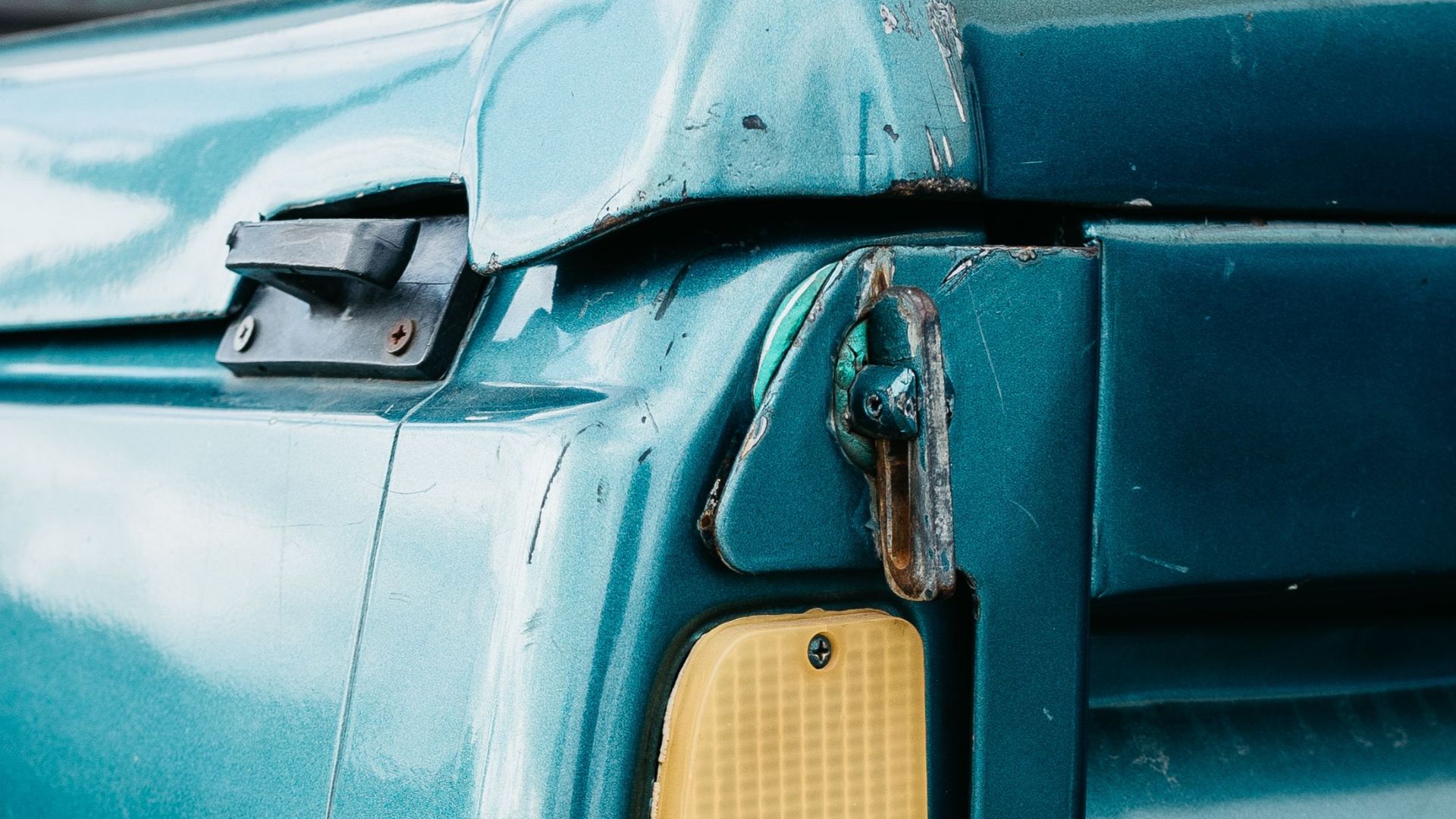 Detailed image of a vintage truck tail light showcasing wear and classic design.