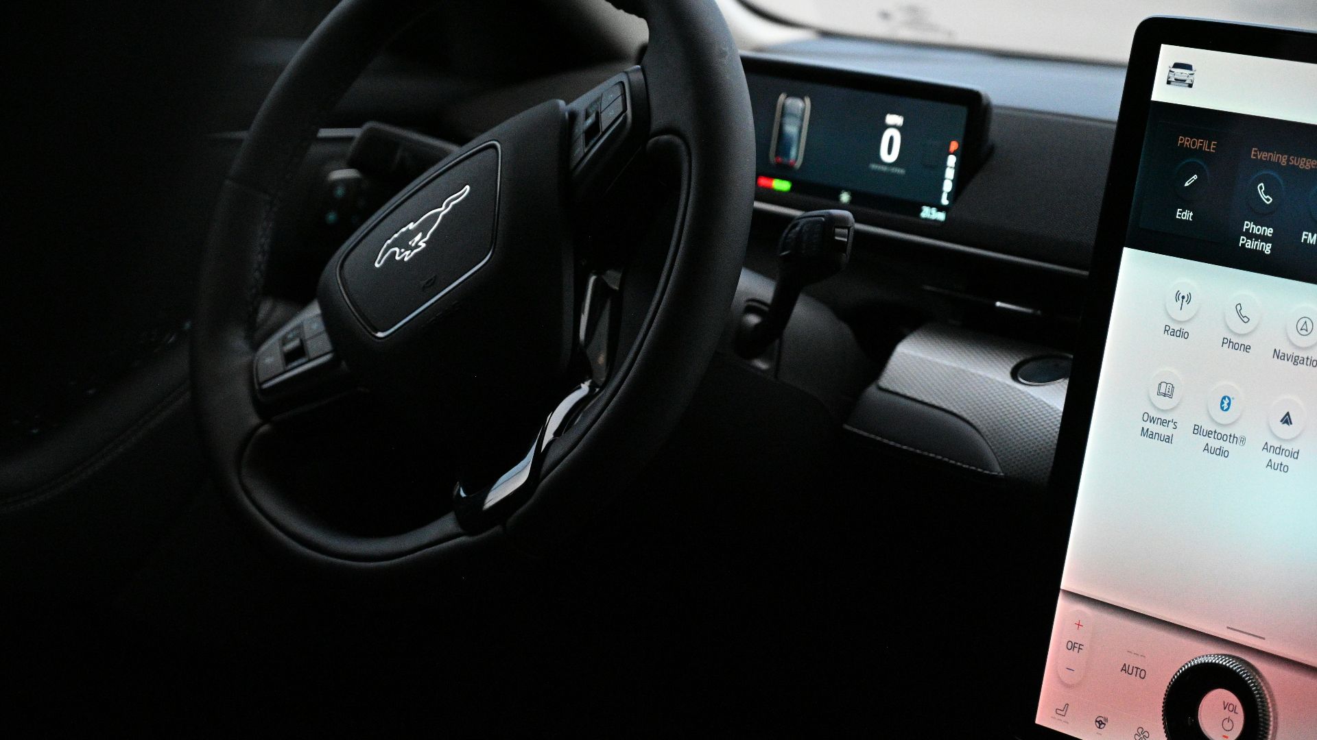 a car dashboard with a touch screen and a steering wheel