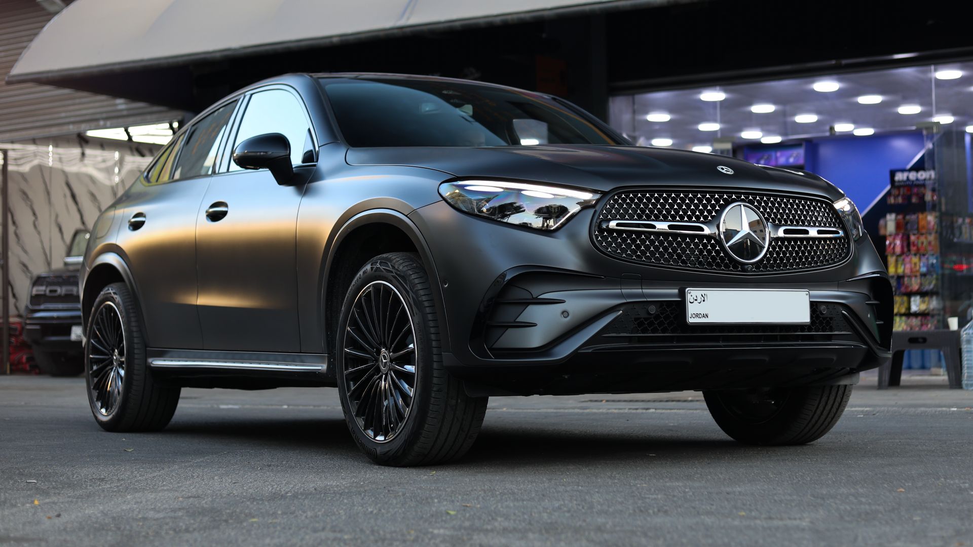 Sleek matte-finish Mercedes-Benz SUV parked in Amman, showcasing luxury design.