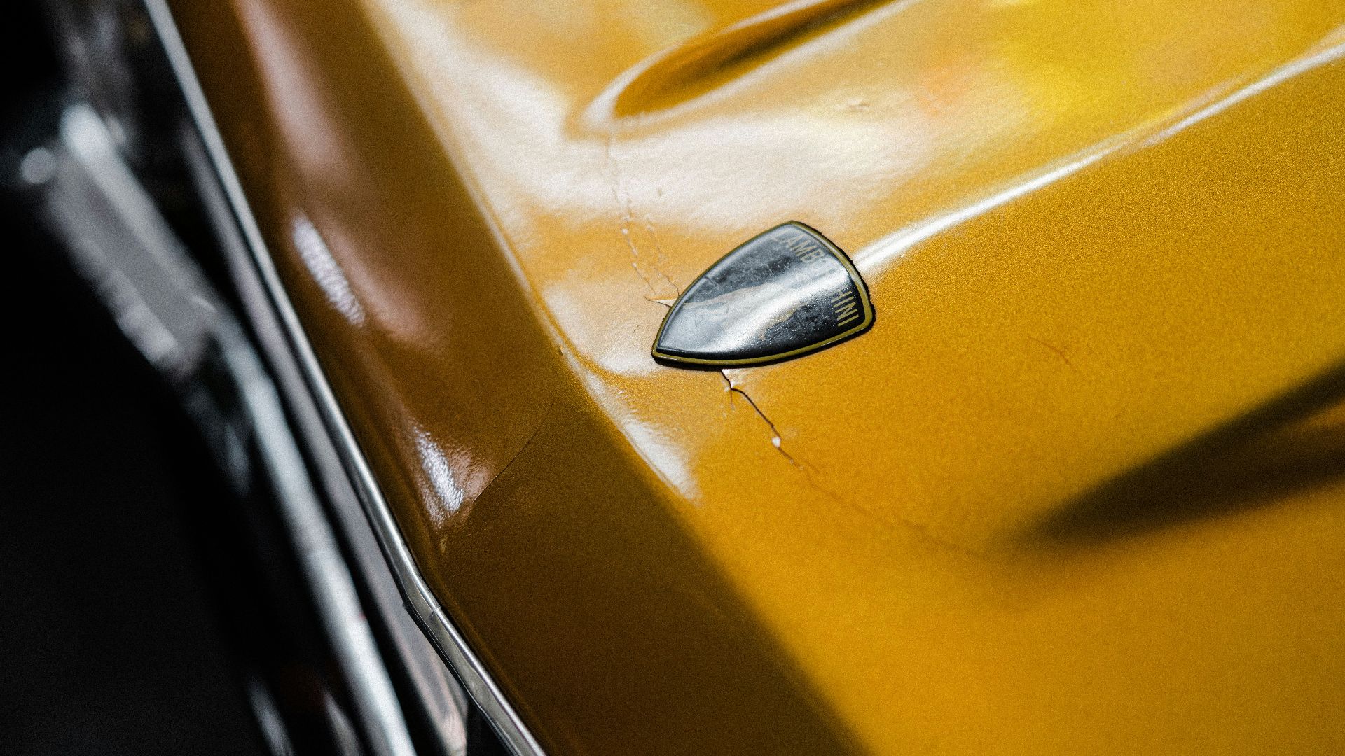 a close up of a yellow car door handle