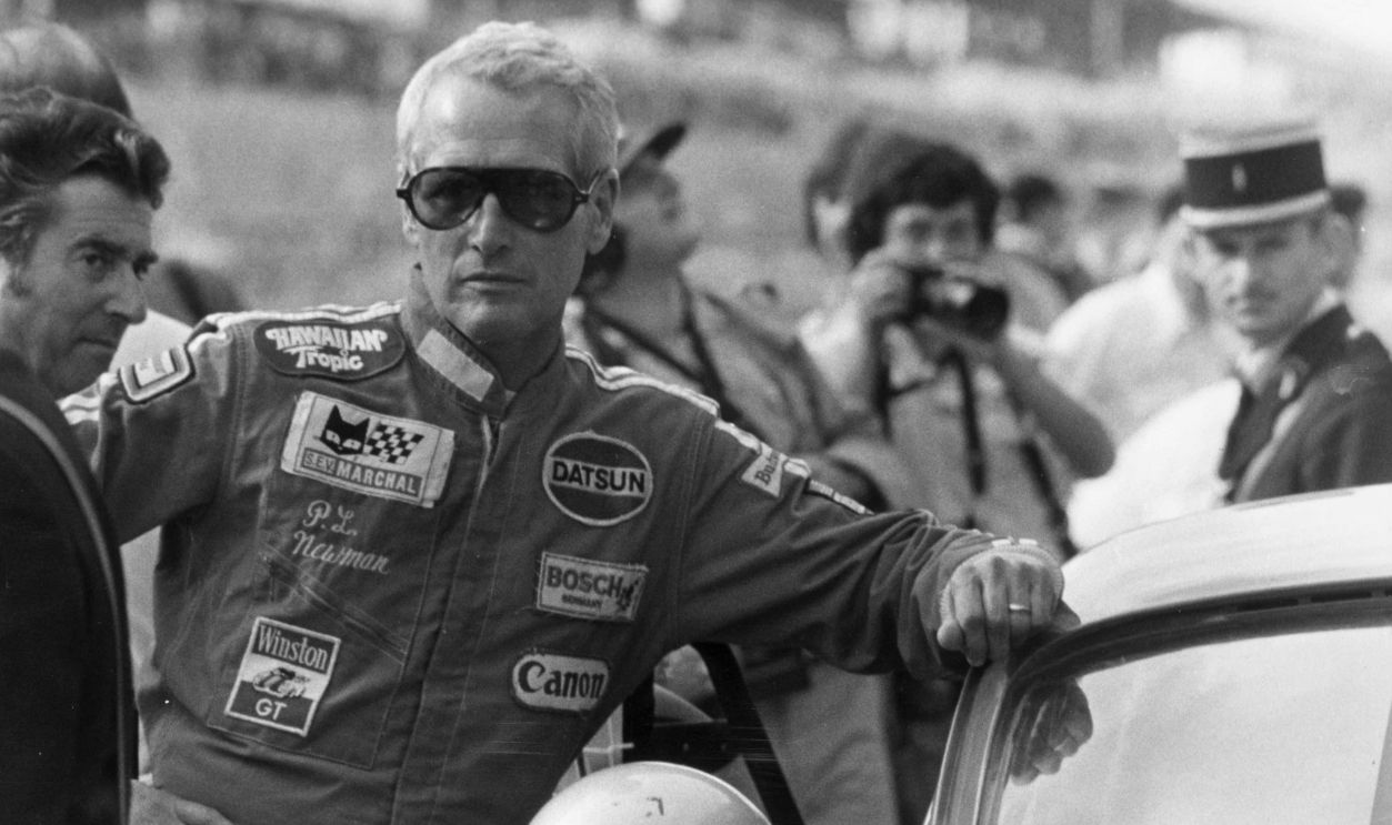 Paul Newman next to a car