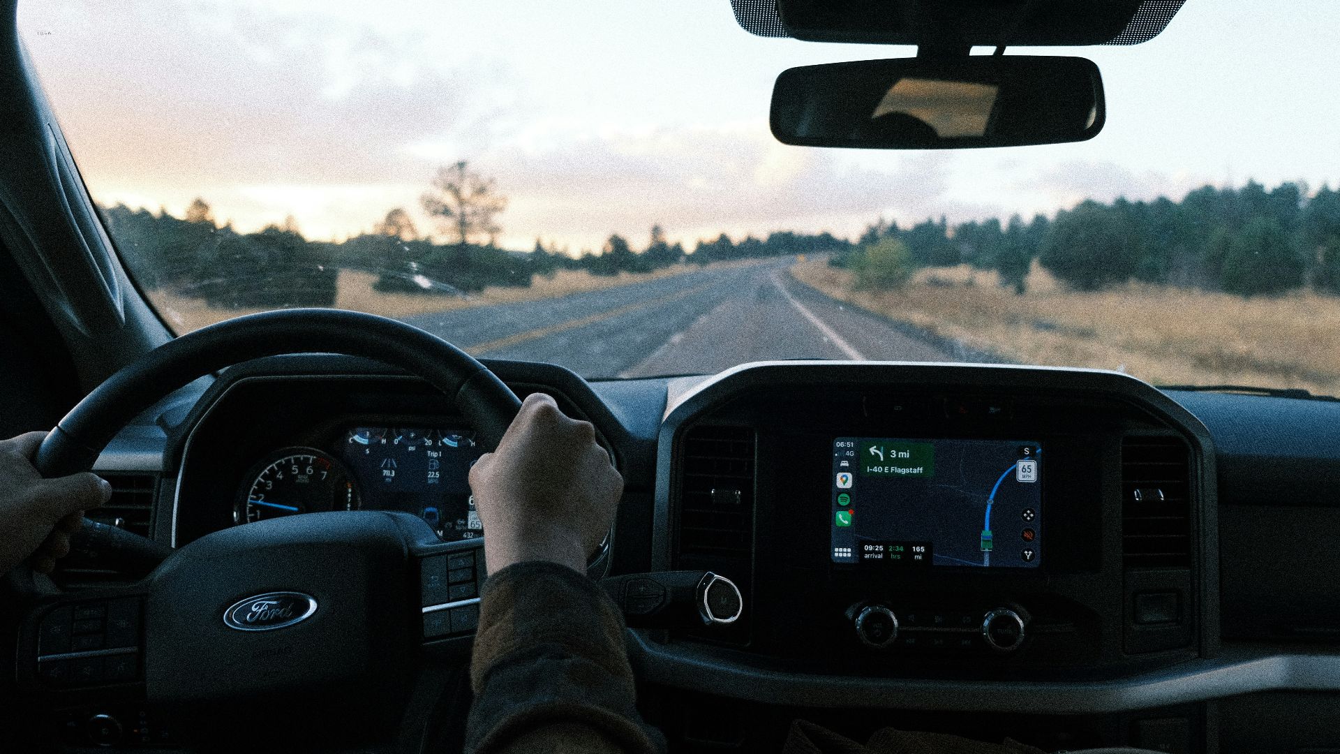 a person driving a truck on a rural road