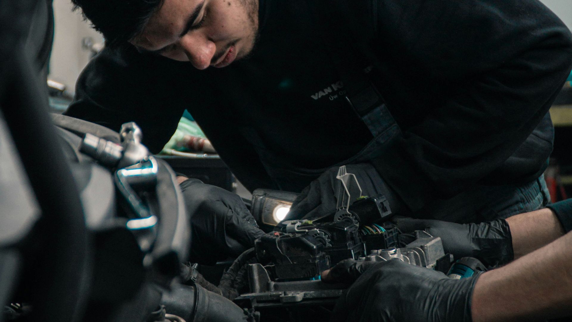 mechanic working on car engine