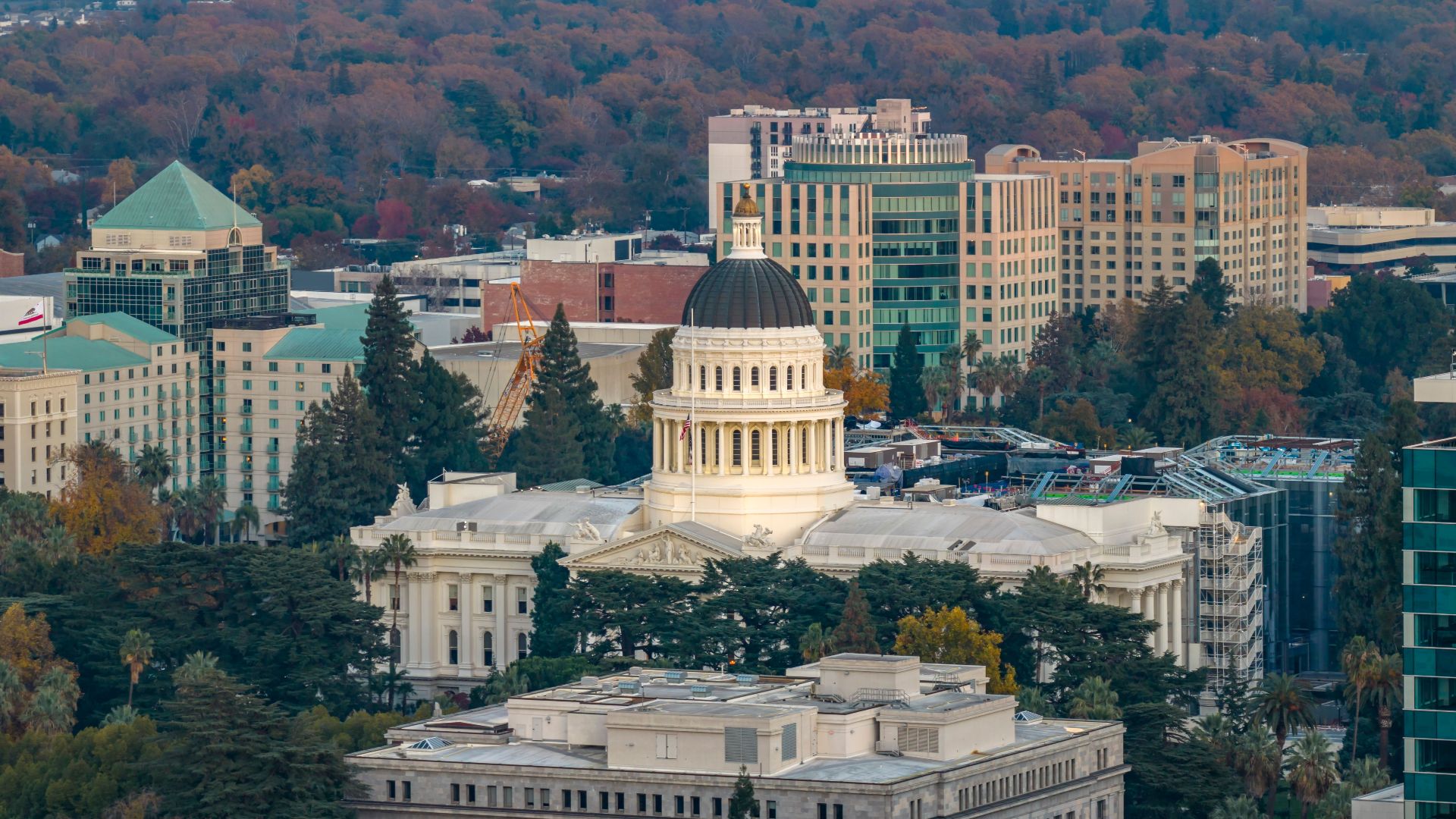 Stunning aerial view of the iconic California State Capitol in Sacramento surrounded by cityscape.