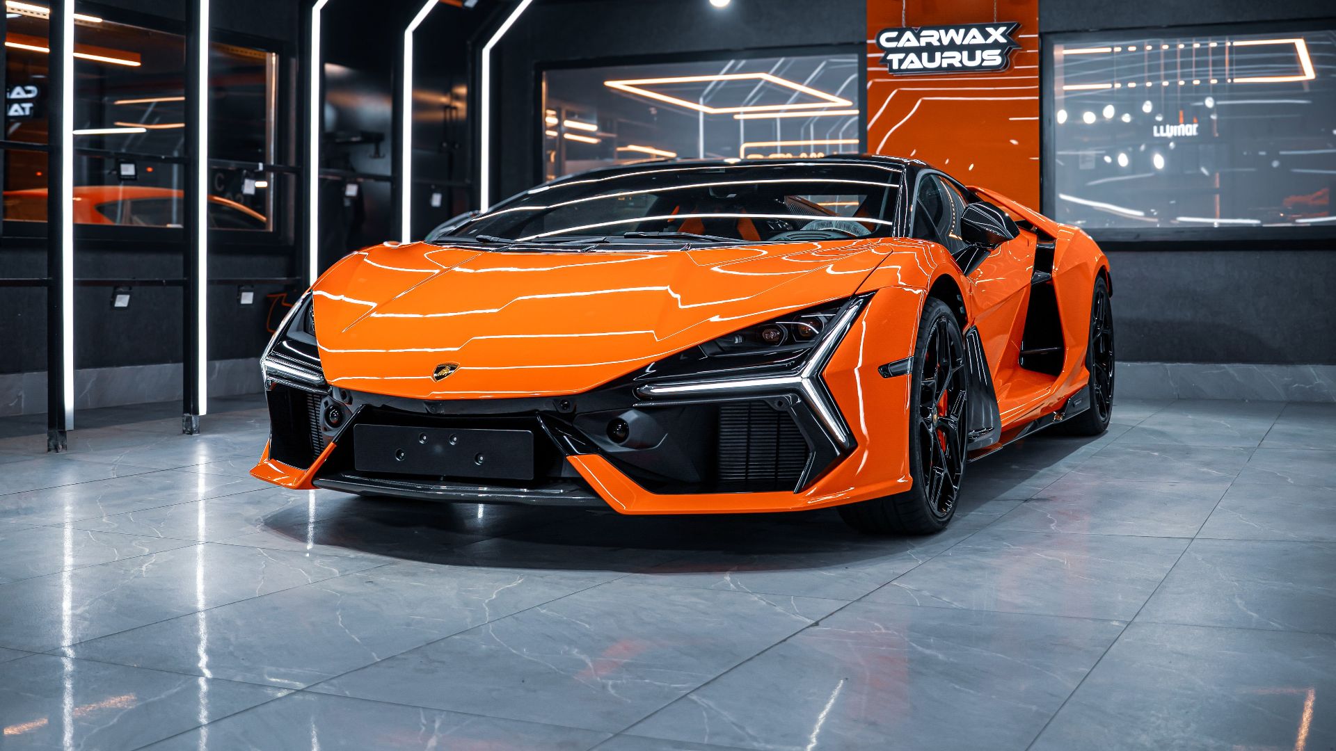An eye-catching orange sports car in a futuristic, well-lit showroom in Ankara, Türkiye.