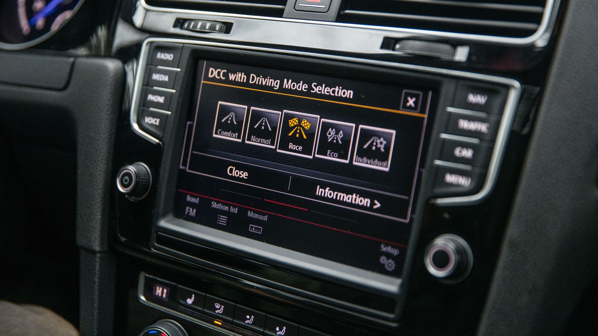 Close-up view of a car's touchscreen display showing driving mode options, enhancing vehicle control.