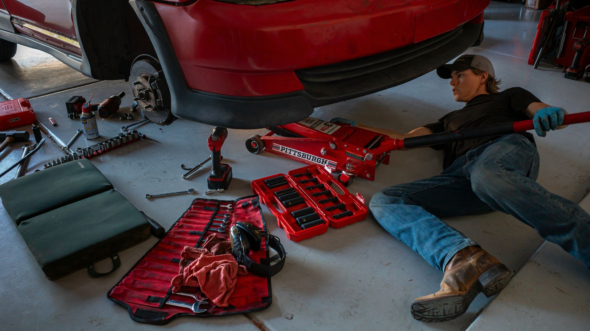 a man working on a car in a garage