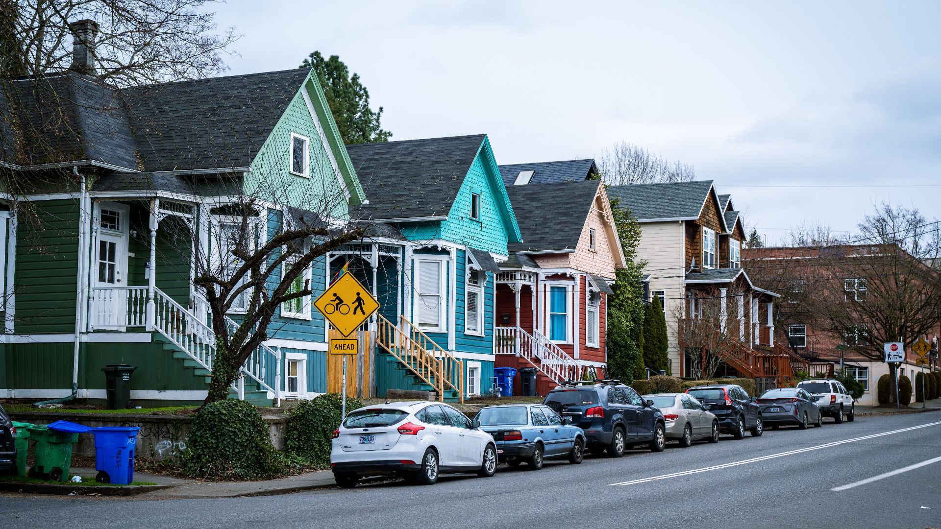 Picturesque street view of colorful, charming houses in a Portland, OR suburb, showcasing urban living.