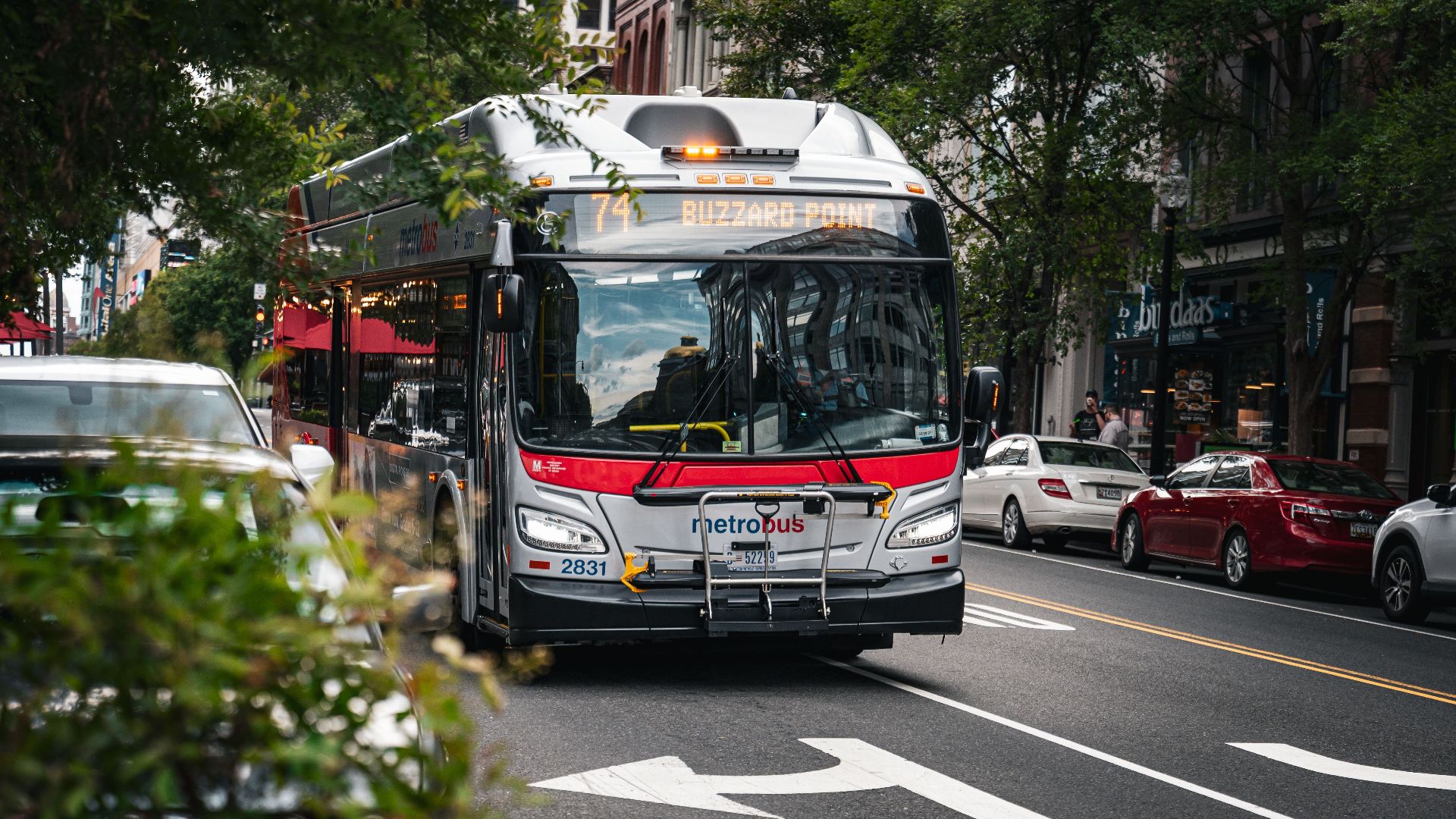 Metrobus driving through Washington D.C., showcasing vibrant city life and urban transportation.