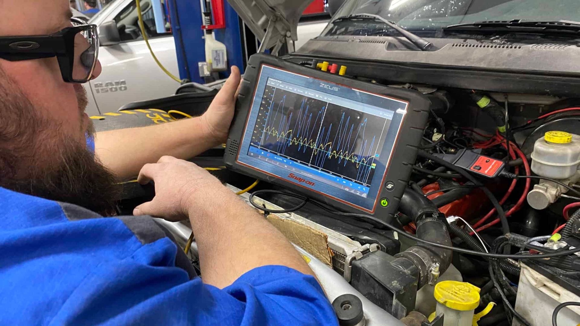 A man is diagnosing a electronic vehicle system
