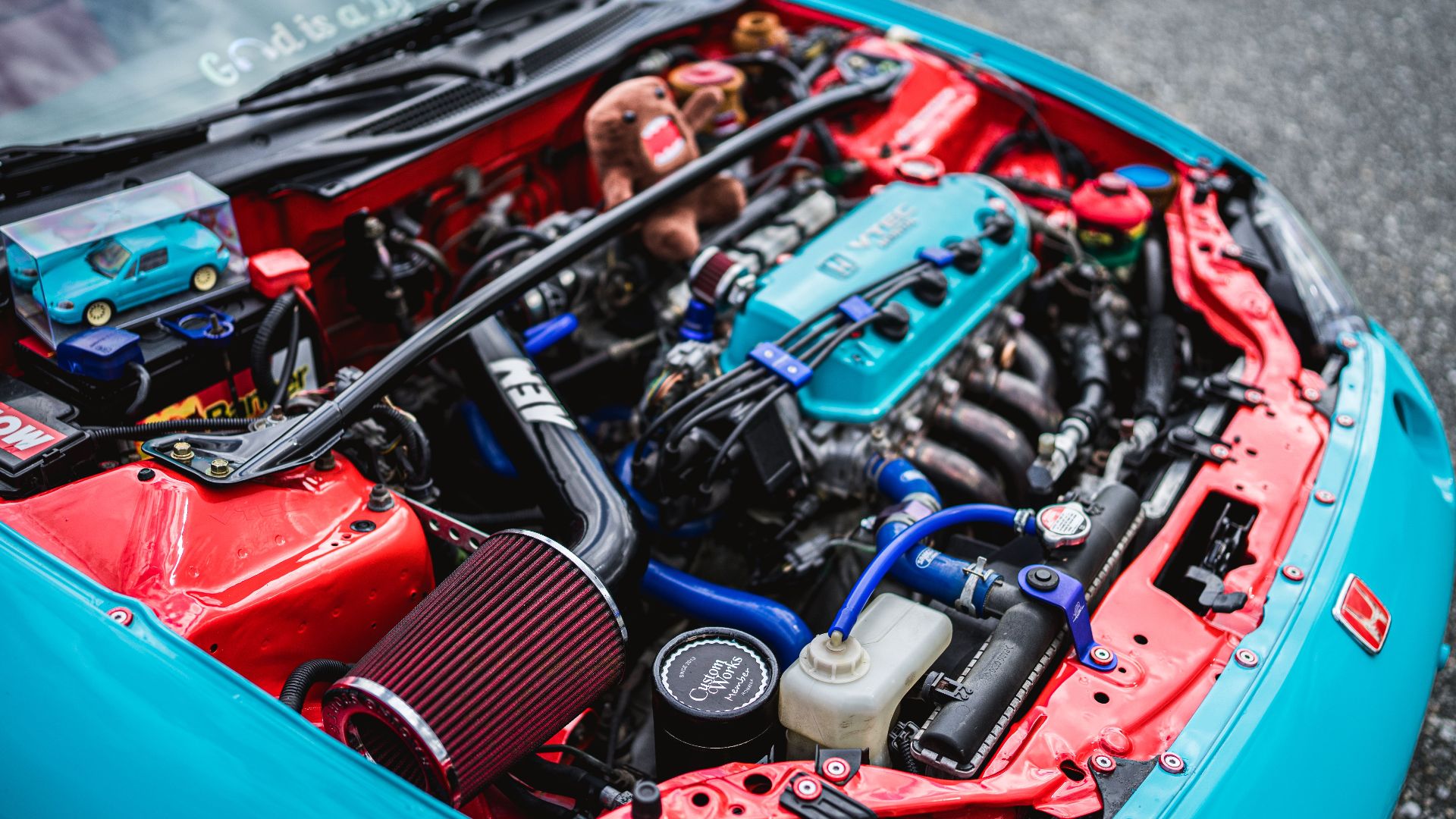 Detailed view of customized Honda engine in vibrant colors.