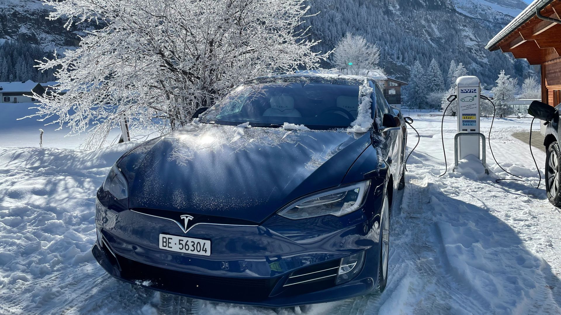 black car on snow covered ground during daytime