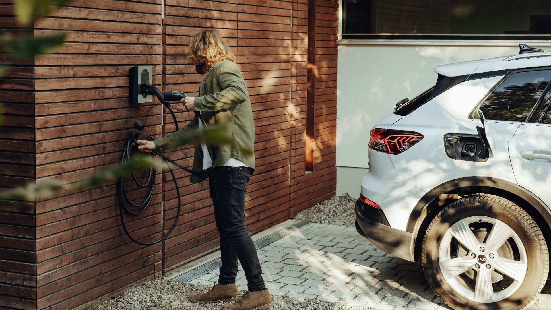 a woman is using a power washer on a brick wall