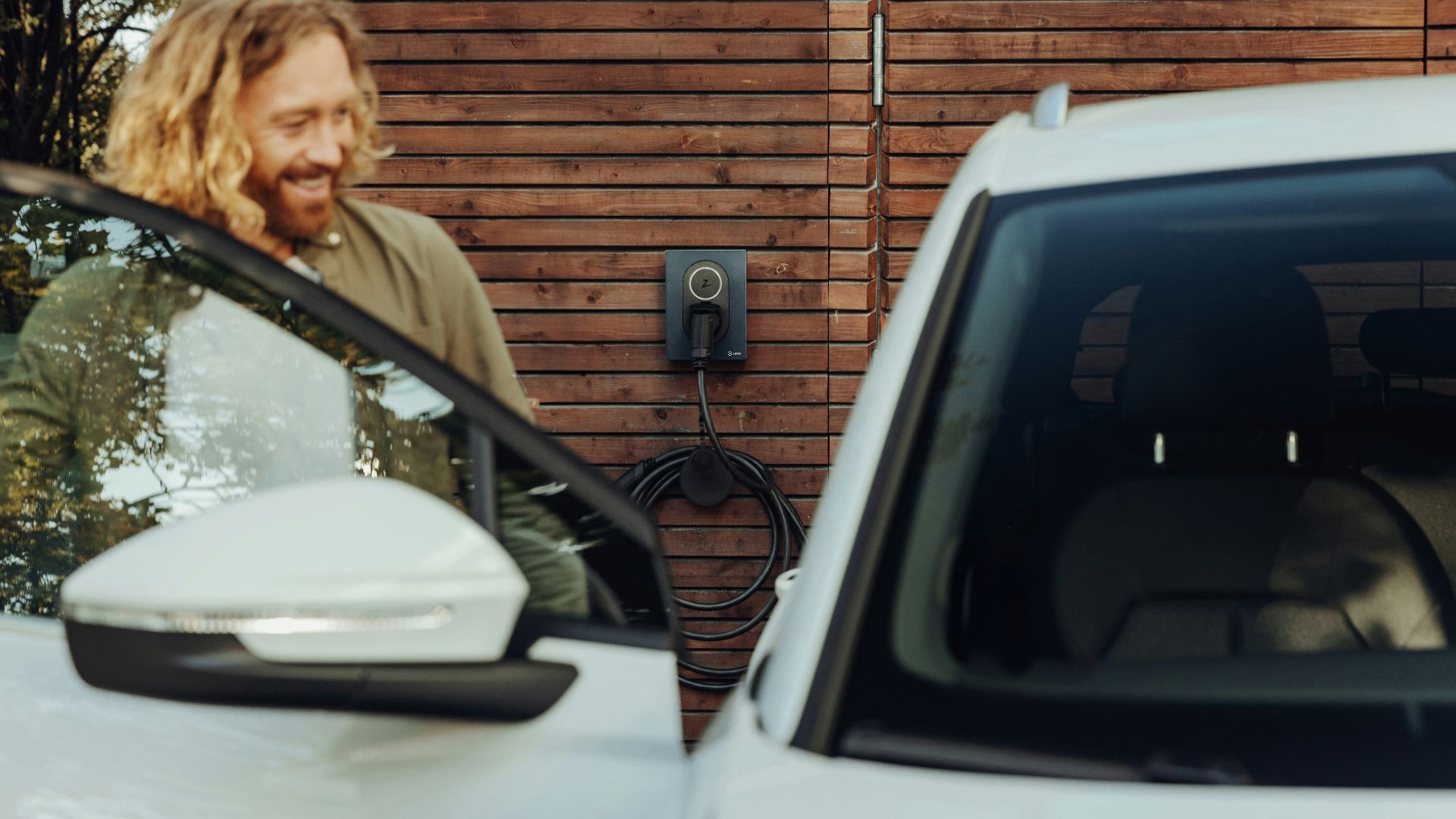 a man standing next to a white car