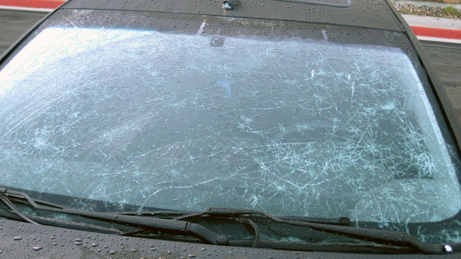 Hailstone damage - broken front windshield of car parked at a motel in Limon, Colorado, USA (morning following a 4 July 2010 hailstorm).
Hailstones are scarce, ephemeral, polycrystalline, concentrically layered, monomineralic rocks of meteoric origin.  Th