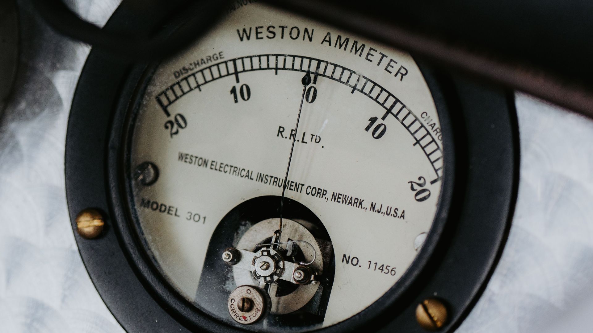 Detailed view of a vintage Weston ammeter gauge, showcasing intricate mechanical design in classic machinery.