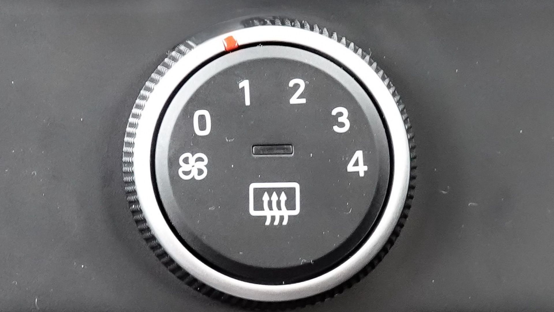 Close-up view of car air conditioning and dashboard controls, featuring climate settings and connectivity ports.
