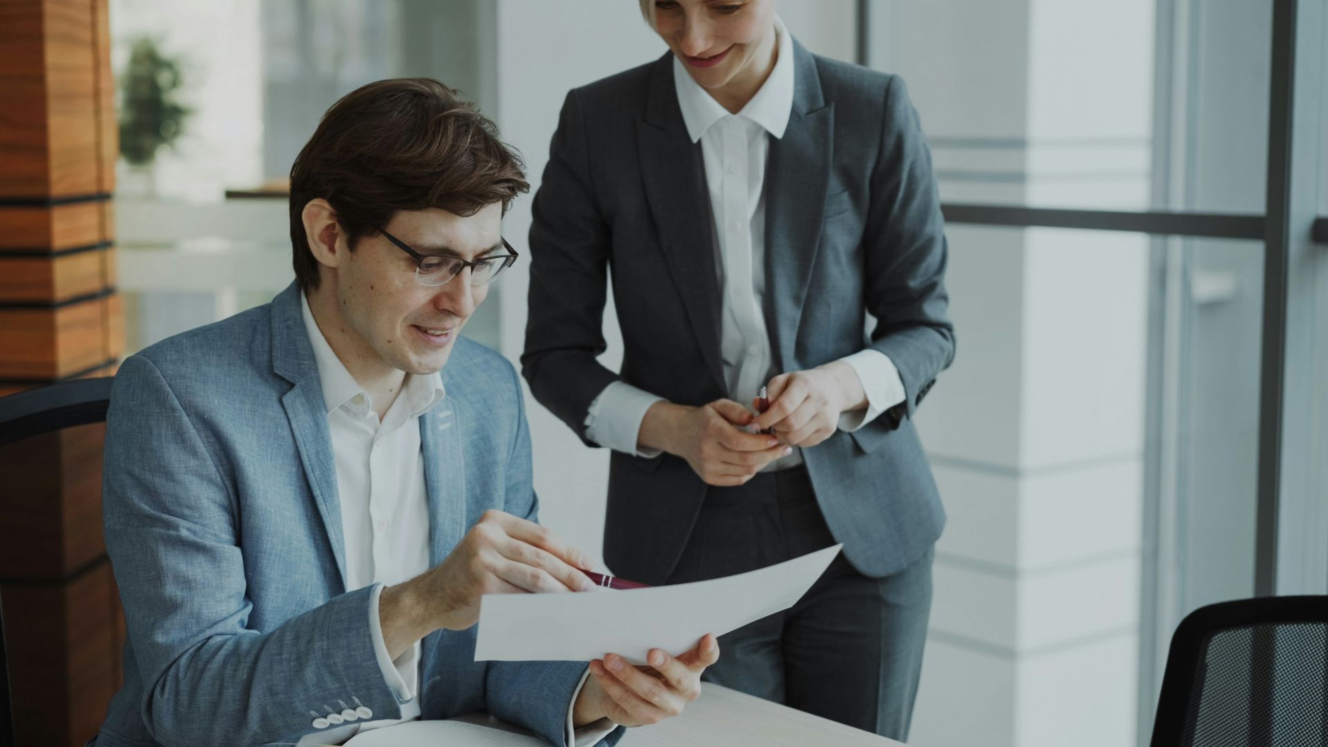 Two business people reviewing documents together