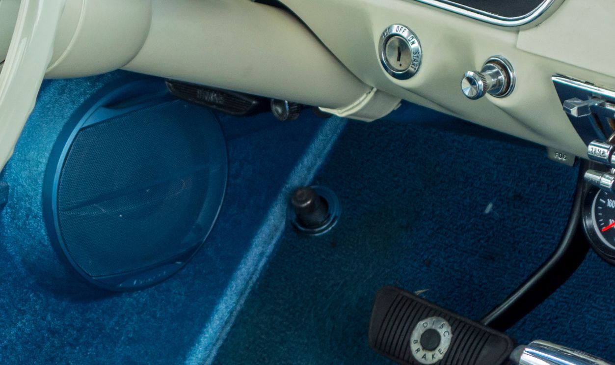 Getty Images - 898366362 - Vintage 1965 Ford Mustang interior showing steering wheel and dashboard in silver blue colors.