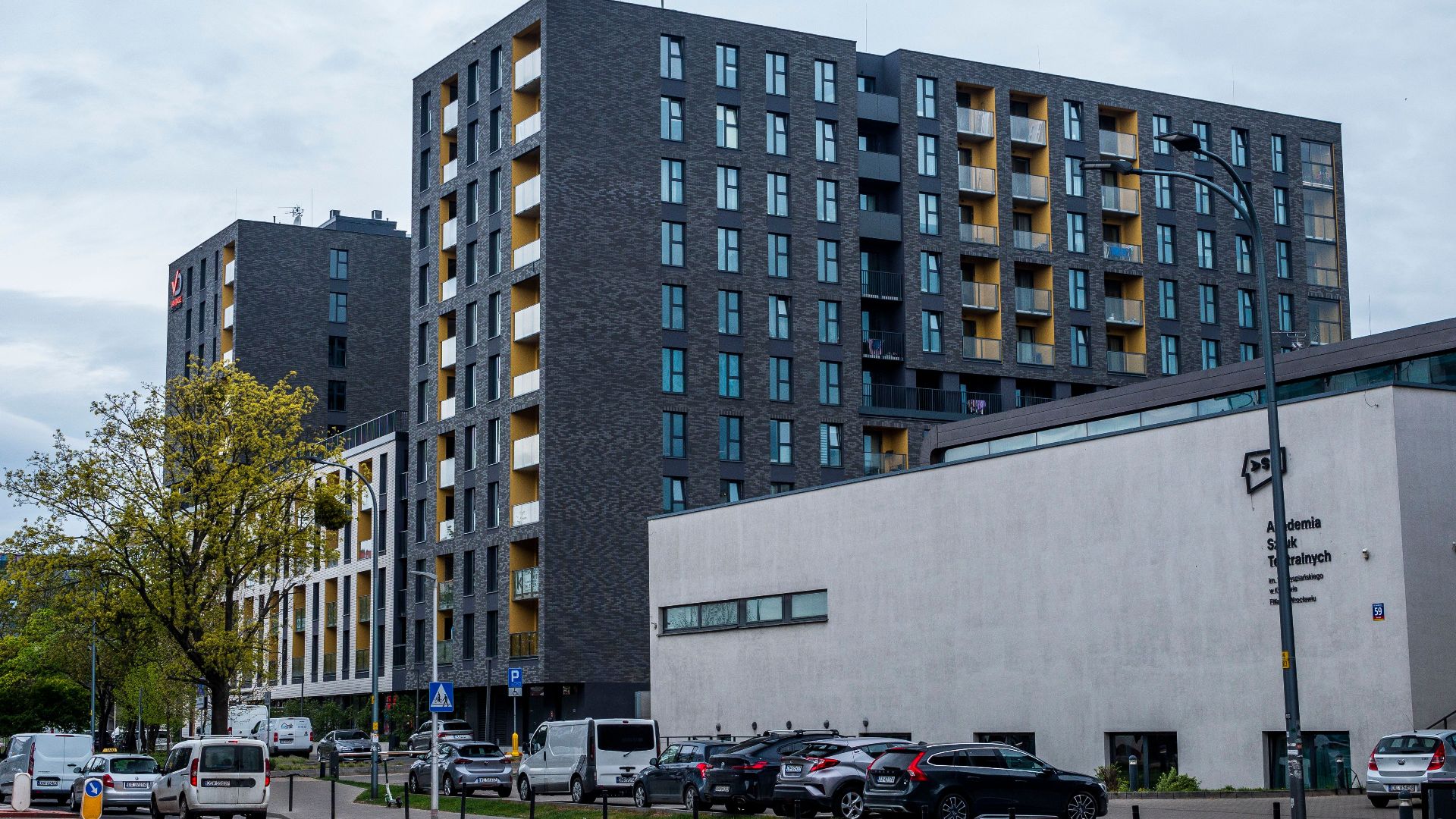 Contemporary architecture of residential buildings in an urban setting, featuring modern design and street elements.