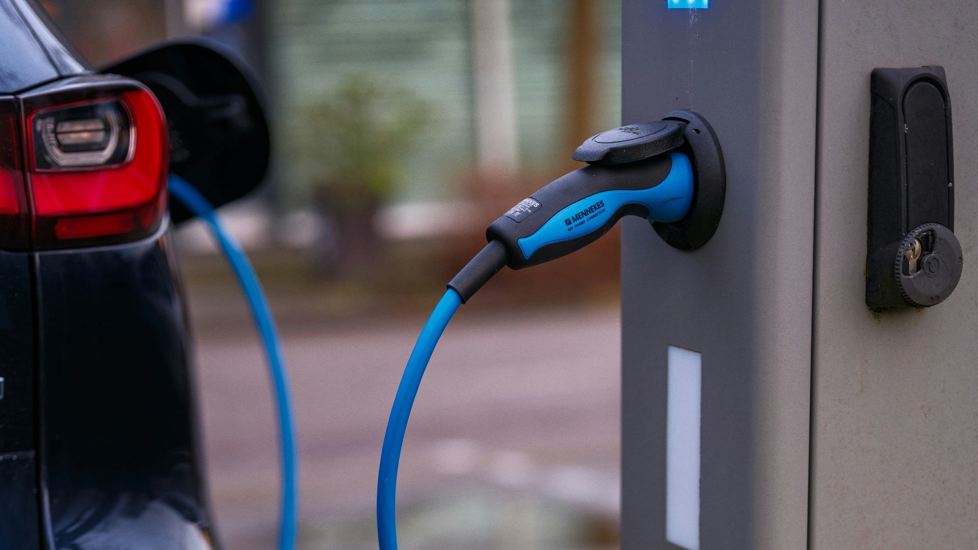 An electric car plugged in to a charging station