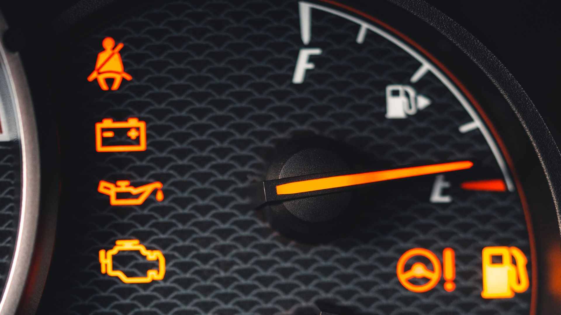 Detailed close-up of car dashboard with various warning lights illuminated.