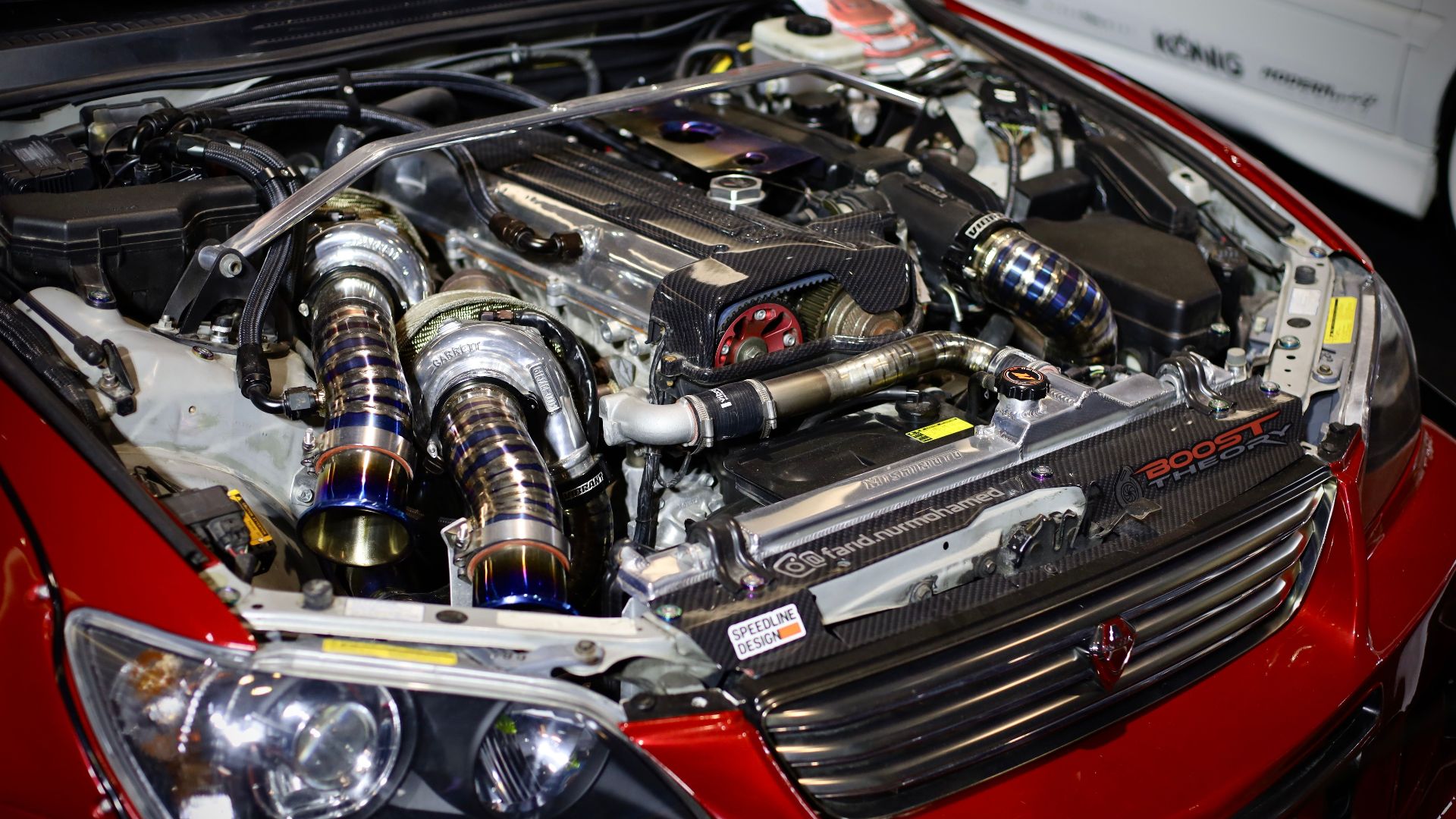 High-performance red car engine with visible turbochargers and enhancements.