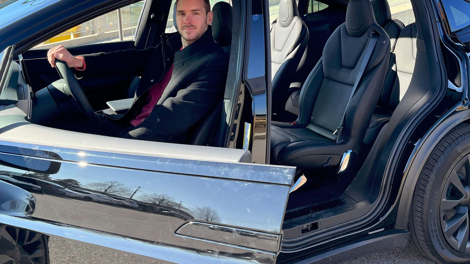 a man sitting in the driver's seat of a car