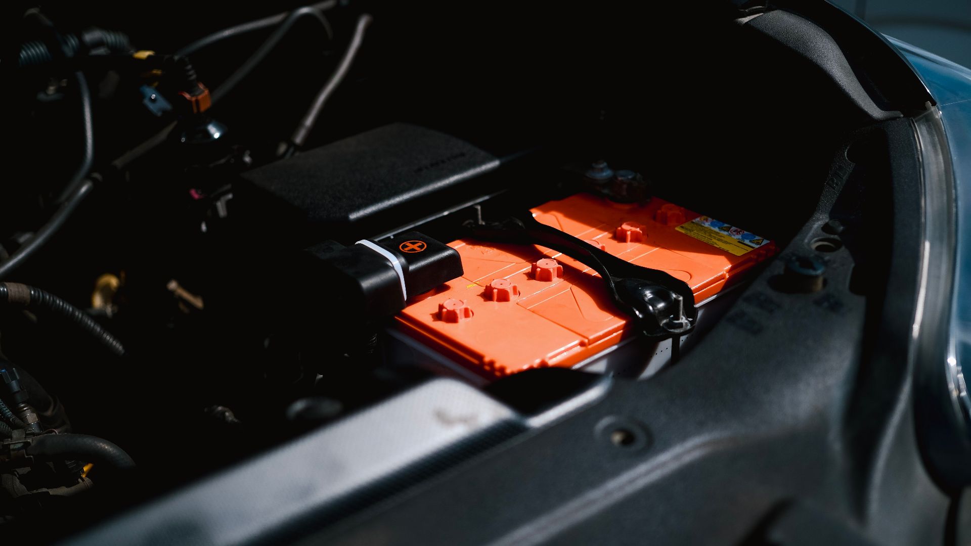 Detailed view of an electric car battery inside a vehicle's engine compartment, highlighting sustainable technology.