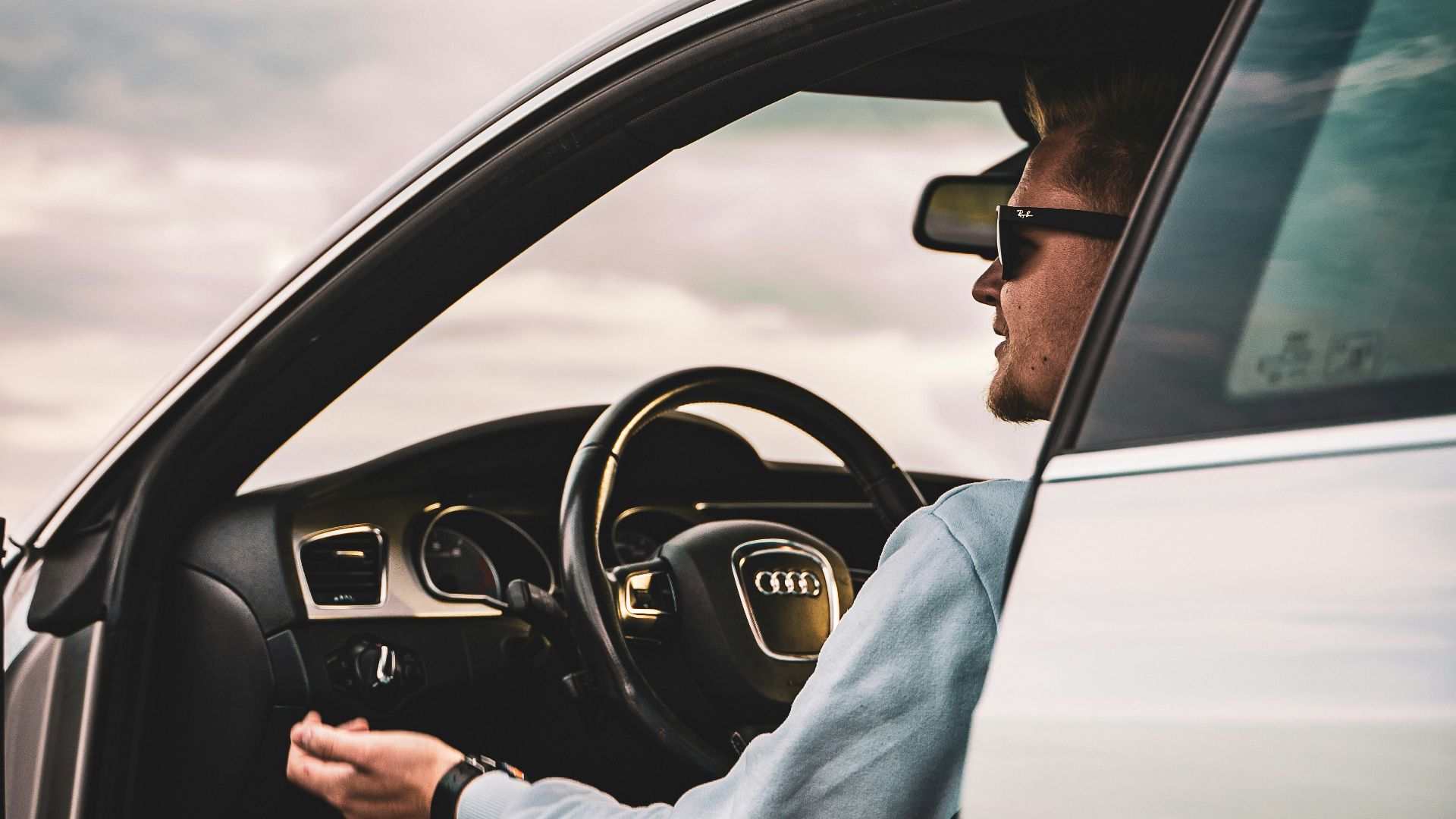 person in gray long sleeve shirt driving car
